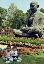  ?? — PRITAM BANDYOPADH­YAY ?? Congress MP Gaurav Gogoi ( clockwise from top, left) with LJP MP Chirag Paswan; two kids sit at the lawn in front of the Gandhi Statue as they along with their parents visit Parliament House and BJP MP S. S. Alluwalia with TMC MPs Dola Sen and Sukhendu...