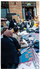  ??  ?? Community spirit: Women at the Al Manaar Muslim Centre with tons of clothes for the victims