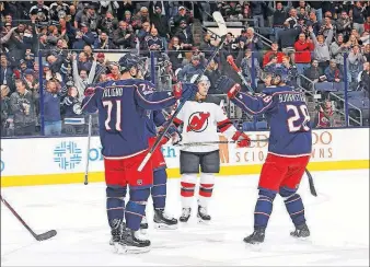  ?? [ADAM CAIRNS/DISPATCH] ?? The Blue Jackets’ Nick Foligno, left, celebrates his first-period goal with Oliver Bjorkstran­d, whose shot he redirected seven seconds after a power play ended.