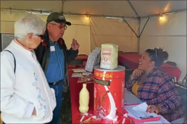  ?? PHOTOS BY NICHOLAS BUONANNO — NBUONANNO@ TROYRECORD. COM ?? Marge and Ron Hathaway receive some informatio­n related to diabetes Friday afternoon at the fair.