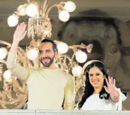  ?? AP ?? El Salvador’s President Nayib Bukele and his wife Gabriela Rodriguez wave to supporters from the balcony of the presidenti­al palace in San Salvador, El Salvador, after polls closed for general elections on Sunday.