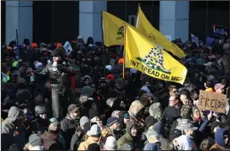  ?? ROB OSTERMAIER/VIRGINIAN PILOT ?? Gun rights protestors chant “We will not comply” as they gather outside the Virginia State Capitol on Monday.