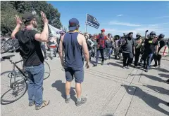  ?? REUTERS ?? Counter-protesters, left, approach supporters of the Patriot Prayer group during the rally.