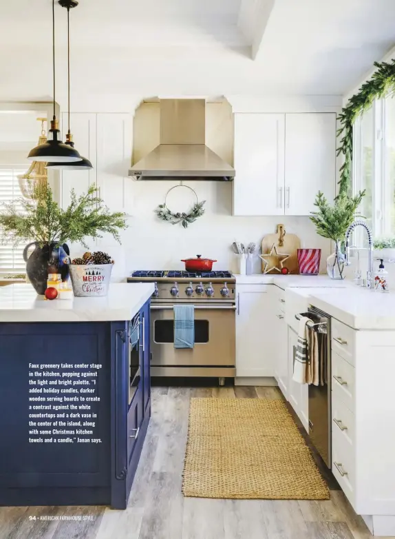  ?? ?? Faux greenery takes center stage in the kitchen, popping against the light and bright palette. “I added holiday candles, darker wooden serving boards to create a contrast against the white countertop­s and a dark vase in the center of the island, along with some Christmas kitchen towels and a candle,” Janan says.