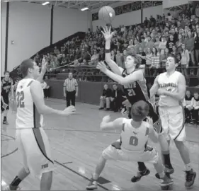  ?? RANDY MOLL NWA NEWSPAPERS ?? Farmington senior Josh Mueller draws an offensive foul on Gravette’s Carson Pollreis. Pollreis sat in the third quarter with foul trouble, alongside shooting ace, Terence Pierce, when Farmington made a run. The Cardinals won 49-48 in the district...