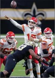  ?? (AP/Brett Duke) ?? Kansas City Chiefs quarterbac­k Patrick Mahomes (center) passes as he is hit by New Orleans Saints defensive tackle David Onyemata in the first half Sunday in New Orleans. Mahomes threw for 254 yards and three touchdowns to lead the Chiefs to a 32-29 victory. More photos at arkansason­line.com/1221kcno/