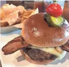  ?? DANIEL HIGGINS / USA TODAY NETWORK-WISCONSIN ?? The 1919 Burger — with Havarti cheese, fried sauerkraut, peppered bacon and topped with red pepper aioli — is available at 1919 Kitchen & Tap at Lambeau Field in Green Bay.