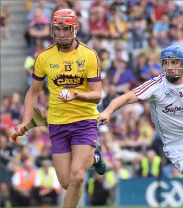  ??  ?? Paul Morris tries to avoid the presence of Galway midfielder Johnny Coen as referee Colm Lyons gets a good