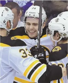  ?? AP PhotoS ?? PULLING IT TOGETHER: Jake DeBrusk is congratula­ted by teammates after his goal in the third period helped the Bruins to a 3-1 victory against the Maple Leafs last night in Toronto; below, Tuukka Rask makes one of his 31 stops as the B’s took a 3-1 lead...