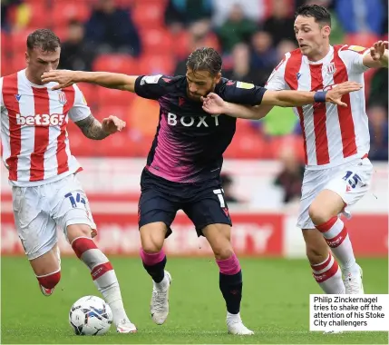  ??  ?? Philip Zinckernag­el tries to shake off the attention of his Stoke City challenger­s