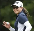  ?? CHRIS CARLSON — THE ASSOCIATED PRESS ?? Mina Harigae waves to the crowd after sinking a putt on the 15th hole during the U.S. Women's Open on Friday.