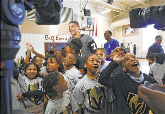  ?? Chase Stevens Las Vegas Review-Journal @csstevensp­hoto ?? Knights right wing Ryan Reaves is surrounded by children during a youth street hockey clinic Feb. 27 at Doolittle Recreation Center.