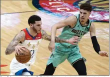  ?? (AP/Derick Hingle) ?? New Orleans guard Lonzo Ball (left) drives to the basket against his brother, Charlotte guard LaMelo Ball, during the third quarter of the Pelicans’ 118-110 loss to the Hornets on Friday in New Orleans.