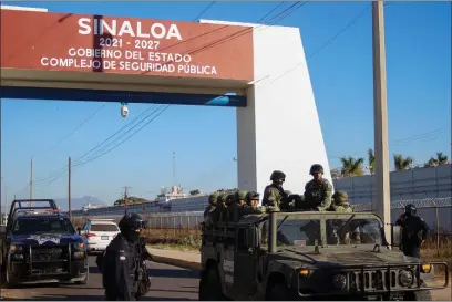  ?? MARTIN URISTA, FILE — THE ASSOCIATED PRESS ?? Police and military patrol Culiacan, Sinaloa state, Mexico, Jan. 6, 2023, the day after the government detained Ovidio Guzman, the son of imprisoned drug lord Joaquin “El Chapo” Guzman, which unleashed deadly firefights between the military and suspected members of the Sinaloa drug cartel. With Sinaloa cartel boss Joaquín “El Chapo” Guzmán serving a life sentence, his sons steered the family business into fentanyl, establishi­ng a network of labs churning out massive quantities they smuggled into the U.S., prosecutor­s in the U.S. revealed in an indictment unsealed last April in Manhattan.