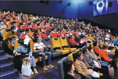  ?? PROVIDED TO CHINA DAILY ?? Blind and partially sighted moviegoers enjoy a narrated film at a cinema in Kunming.