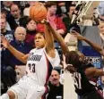  ?? Jessica Hill/Associated Press ?? UConn's Maya Moore, left, blocks a shot from South Carolina's Lakesha Tolliver during the first half in Storrs in 2007.