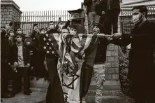  ?? Arash Khamooshi / New York Times ?? Protesters burn an American and Israeli flag in Tehran on Saturday, a day after the killing of Iranian nuclear scientist Mohsen Fakhrizade­h. The killing has raised fears of retributio­n.