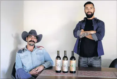  ?? AP PHOTO ?? Alex Howe (right) and Chip Forsythe, co-founders of Rebel Coast, pose for photos with their cannabis-infused wine in Los Angeles.