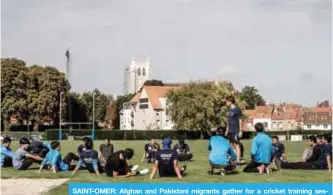  ??  ?? SAINT-OMER: Afghan and Pakistani migrants gather for a cricket training session in Saint-Omer, northern France.— AFP