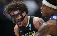  ?? AARON DOSTER — THE ASSOCIATED PRESS ?? Colorado's J'Vonne Hadley, left, reacts after colliding with Boise State's Chibuzo Agbo in an NCAA Tournament First Four game.