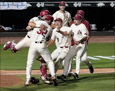  ?? NWA Democrat-Gazette/J.T. WAMPLER ?? The Razorbacks celebrate after defeating South Carolina 14-4 on Monday in the Fayettevil­le Super Regional championsh­ip game at Baum Stadium. Arkansas qualified for its ninth College World Series and fifth under Coach Dave Van Horn.