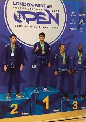  ??  ?? Adam Akasyah (second from left) celebrates on the podium at the London Winter Open Jiu-Jitsu Championsh­ip on Saturday.