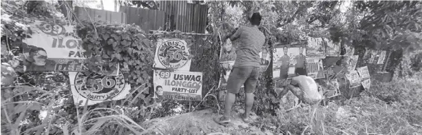  ?? ?? Campaign posters are being removed from a fence in Pavia, Iloilo. The provincial government has ordered an Iloilo-wide post-election cleanup.