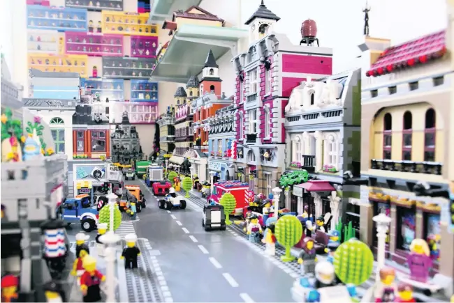  ??  ?? A miniature city, populated with Lego characters, cars and cafeterias, built by Philippe Gerard. The 55-year-old says he was introduced to Lego as a child, and began collecting seriously in the 1980s.