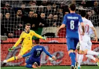  ?? — AFP ?? Italy striker Lorenzo Insigne scores against Spain.