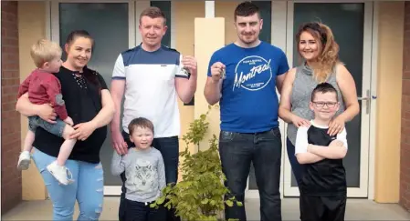  ??  ?? Residents Amy Furlong and Brian Nolan and sons Lee and Alex pictured with thier neighbours, Alan Lambert, Denise Redmond and son Jack as they are handed the keys to their new local authority passive houses at Madeira Oaks in Enniscorth­y.