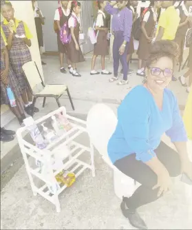  ?? ?? Teacher, Marcia Gordon showcasing a bathroom shelf unit and a toilet that she made from tyres and pipes