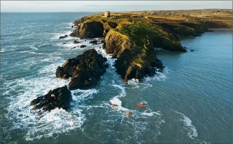  ??  ?? A drone shot of Martello tower with a group nearby.