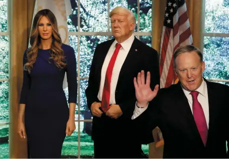  ??  ?? Former White House Press Secretary Sean Spicer poses next to newly unveiled wax figures of US First Lady Melania Trump and President Donald Trump at Madame Tussauds wax museum in New York City yesterday. Photo: Reuters/Mike Segar