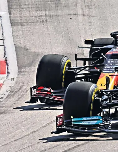  ?? ?? Early advantage: Red Bull’s Max Verstappen is beaten off the start line by Lewis Hamilton in the Mercedes