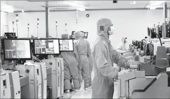  ?? LIU HUI / FOR CHINA DAILY ?? Employees monitor the chip-making production line at a tech company in Southwest China’s Chongqing.