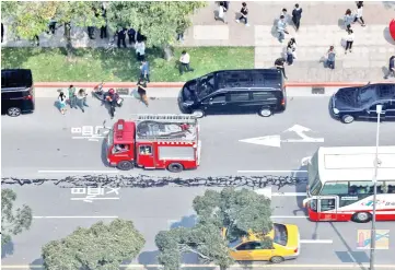  ??  ?? Spilled asphalt is seen on a major road in the centre of Taipei,Taiwan. — Reuters photos