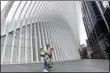  ?? KATHY WILLENS — THE ASSOCIATED PRESS ?? Two people carry their groceries past the Oculus at the World Trade Center, Sunday, April 5, in New York, during the ongoing coronaviru­s pandemic.