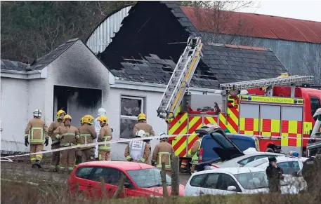  ?? Photo: Brian Lawless/PA Wire ?? Forensic and fire officers at the house in Derrylin, Co Fermanagh, where three people died in a fire.