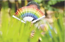  ?? REUTERS ?? A MEMBER of the lesbian, gay, bisexual, transgende­r, intersex and queer community poses for a picture with rainbow colors in Kampala, Uganda, April 4.