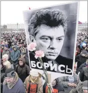  ?? DMITRI LOVETSKY / AP ?? People gather in memory of opposition leader Boris Nemtsov in St. Petersburg, Russia, on Sunday. Rallies in St. Petersburg and Moscow marked two years since Nemtsov was shot outside the Kremlin.