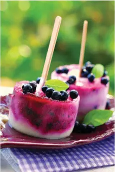  ?? AdobeStock ?? ■ Homemade blueberry and yogurt pops with fresh fruit.