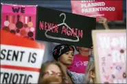  ?? CHARLIE NEIBERGALL - THE ASSOCIATED PRESS ?? In this May 21file photo, August Mulvihill, of Norwalk, Iowa, center, holds a sign depicting a wire clothes hanger during a rally at the Statehouse in Des Moines, Iowa, to protest recent abortion bans. On Wednesday, Nov. 6, a federal judge in New York struck down a rule letting health care clinicians object to providing abortions and other services on moral or religious grounds.