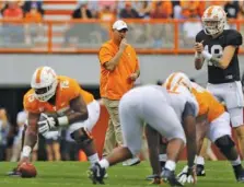  ?? STAFF PHOTO BY C.B. SCHMELTER ?? Tennessee football coach Jeremy Pruitt looks on before the ball is snapped during the Orange and White spring game at Neyland Stadium on April 13.