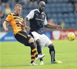  ??  ?? Raith’s Jean-Yves M’Voto keeps Greig Spence at bay. Picture: Getty.