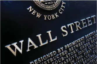  ??  ?? NEW YORK: An historic marker on Wall Street in New York. Japan led global stock markets higher on Friday after its central bank introduced a negative interest rate policy in the latest move to overcome malaise in the world’s third-biggest economy. The...