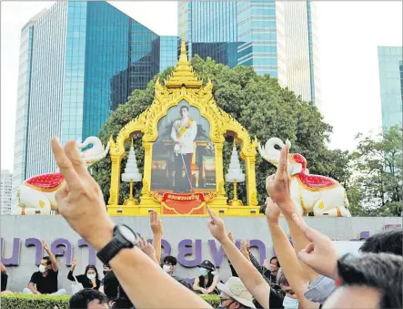  ?? Picture: REUTERS ?? Protesters show three-finger salute during a pro-democracy rally demanding Thailand’s King Maha Vajiralong­korn hands back royal assets to the people and reforms on the monarchy, in Bangkok, Thailand.