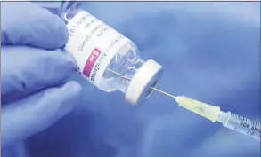  ?? Matthias Bein / TNS ?? A syringe is filled with COVID-19 vaccine AstraZenec­a.