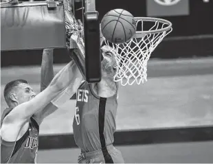  ?? Mark Mulligan / Staff photograph­er ?? Rockets forward K.J. Martin, blocking a shot by Mavericks center Kristaps Porzingis, has blocked several 7-footers this year.