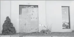  ?? Photo by Ernest A. Brown ?? This window at Precision Harley Davidson on Armistice Blvd., Pawtucket, is boarded up Friday after a crash Thursday night.