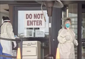  ?? Matthew Brown / Hearst Connecticu­t Media file photo ?? Stamford Hospital nurses wear protective gowns, gloves and masks in an area outside the hospital that had been set up to test for the COVID-19 virus in Stamford, Connecticu­t on March 17, 2020.